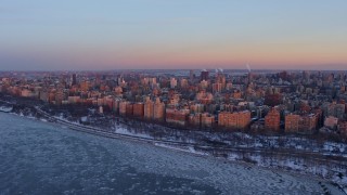 AX66_0276E - 4.8K aerial stock footage of Upper West Side apartment buildings in winter, New York City twilight