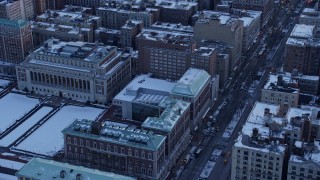 AX66_0284E - 4.8K aerial stock footage of a bird's eye view of a Columbia University building in winter, New York City, twilight