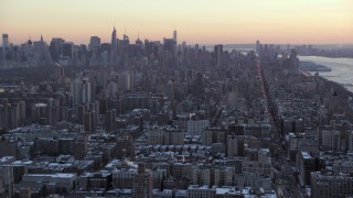 AX66_0287 - 4.8K aerial stock footage tilt from Midtown skyline, reveal Columbia University in winter, New York City, twilight