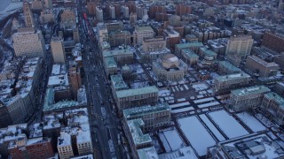 AX66_0289E - 4.8K aerial stock footage tilt from Columbia University in winter, reveal Harlem, New York City, twilight