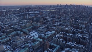 AX66_0291 - 4.8K aerial stock footage of Columbia University, reveal Midtown Manhattan skyline in winter, New York City, twilight