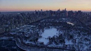 AX66_0298E - 4.8K aerial stock footage of Central Park and Metropolitan Museum of Art in winter, New York City, twilight