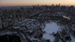 AX66_0301 - 4.8K stock footage aerial video approach Metropolitan Museum of Art in Central Park in winter, New York City, twilight