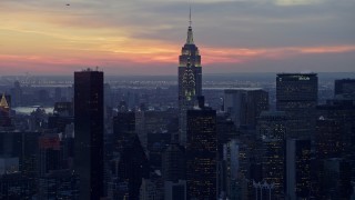 AX66_0320E - 4.8K aerial stock footage of Chrysler and Empire State Building in Midtown, winter, New York City, twilight