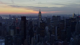 AX66_0323 - 4.8K aerial stock footage approach famous Chrysler Building and Empire State Building in winter, New York City, twilight