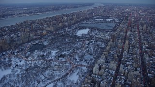 AX66_0330E - 4.8K aerial stock footage of bare trees in Central Park in winter, New York City, twilight