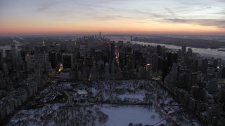 AX66_0333 - 4.8K stock footage aerial video of Midtown Manhattan seen from Central Park in winter, New York City, twilight