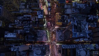 AX66_0337E - 4.8K aerial stock footage tilt to a bird's eye view of Times Square in winter, New York City, twilight