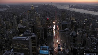 AX66_0338 - 4.8K stock footage aerial video tilt to Times Square and Midtown in winter, New York City, twilight