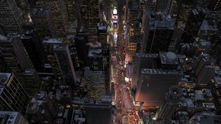 AX66_0339 - 4.8K aerial stock footage tilt to a bird's eye view of Times Square in winter, New York City, twilight
