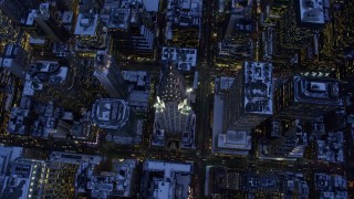 AX66_0350E - 4.8K aerial stock footage approach the Chrysler Building in snow, New York City, twilight