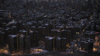 AX66_0359 - 4.8K aerial stock footage flyby East Village apartment buildings in winter, New York City, twilight
