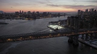 AX66_0360 - 4.8K aerial stock footage of Williamsburg Bridge and Lower East Side in winter, New York City, twilight
