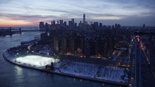 AX66_0360E - 4.8K aerial stock footage of Williamsburg Bridge, Lower East Side, Lower Manhattan in winter, New York City, twilight