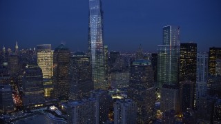 AX66_0380E - 4.8K aerial stock footage of One World Trade Center and Memorial in winter, New York City, twilight