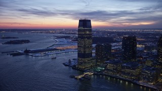 AX66_0383 - 4.8K aerial stock footage of Goldman Sachs Tower in Jersey City in winter, New Jersey, twilight