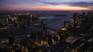 AX66_0393 - 4.8K aerial stock footage of Manhattan and Brooklyn Bridges in winter, New York City, twilight
