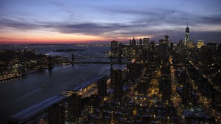 AX66_0395 - 4.8K aerial stock footage of Manhattan and Brooklyn Bridges, Lower East Side apartments in winter, New York City, twilight