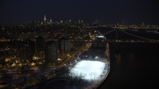 AX66_0409 - 4.8K aerial stock footage of Lower East Side and Williamsburg Bridge in winter, New York City, night