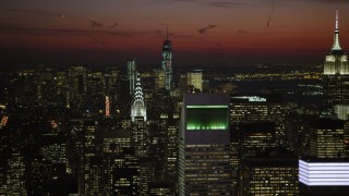 AX66_0429 - 4.8K aerial stock footage of Lower Manhattan skyscrapers, Chrysler, and Empire State Building, New York City, night