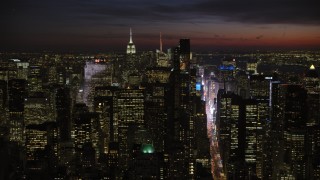 AX66_0432 - 4.8K aerial stock footage of Midtown Manhattan skyscrapers, New York City, night