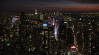 AX66_0433 - 4.8K aerial stock footage of Times Square and Midtown Manhattan skyscrapers, New York City, night