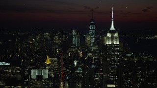 AX66_0437 - 4.8K aerial stock footage of Empire State Building and Lower Manhattan skyscrapers, New York City, night