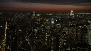 AX66_0439 - 4.8K stock footage aerial video of Empire State and Chrysler Building with view of Lower Manhattan skyscrapers, New York City, night