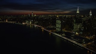 AX66_0440E - 4.8K aerial stock footage of a view of Midtown and Lower Manhattan skyscrapers, New York City, night