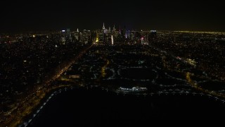 AX67_0015 - Aerial stock footage of 4.8K aerial video view of flying over the Central Park reservoir to approach Midtown skyline, New York City, New York