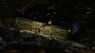 AX67_0016 - 4.8K aerial stock footage view of the front steps of the Museum of Natural History at night, Upper West Side, NYC, New York