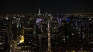 AX67_0017 - 4.8K aerial stock footage view fly over 6th Avenue toward Midtown Manhattan at night, New York City, New York