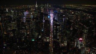 AX67_0027 - Aerial stock footage of 4.8K aerial video view follow 7th Avenue to approach Times Square at night, Midtown Manhattan, New York City, New York