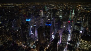 AX67_0031 - 4.8K aerial stock footage view circling the bright lights of Times Square at night, Midtown Manhattan, New York City, New York