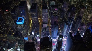 AX67_0032 - Aerial stock footage of 4.8K aerial video view tilt to the bright lights of Times Square at night, Midtown Manhattan, New York City, New York