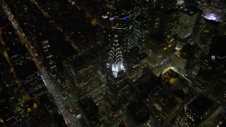 AX67_0038 - 4.8K aerial stock footage view approach Chrysler Building and tilt to bird's eye view at night in Midtown Manhattan, New York City, New York