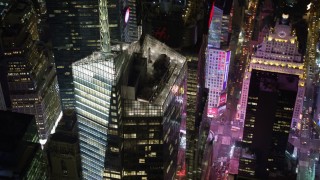 AX67_0043 - 4.8K aerial stock footage view of orbiting Bank of America Tower skyscraper at night, Midtown Manhattan, New York City, New York