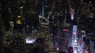 AX67_0045 - 4.8K aerial stock footage view of orbiting Bank of America Tower and fly away at night, Midtown Manhattan, New York City, New York