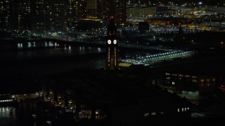 AX67_0066 - 4.8K aerial stock footage view of approaching Hoboken Terminal at night, New Jersey