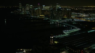 AX67_0067 - 4.8K aerial stock footage view fly over Hoboken Terminal at night, approach Downtown Jersey City, New Jersey