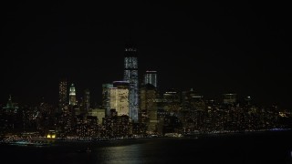 AX67_0068 - 4.8K aerial stock footage view of World Trade Center skyscrapers seen from New Jersey at night