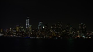 AX67_0075 - 4.8K aerial stock footage view of approaching Lower Manhattan skyline at night, New York