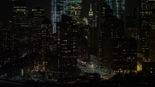 AX67_0076 - 4.8K aerial stock footage view of flying by Lower Manhattan skyscrapers at night, New York