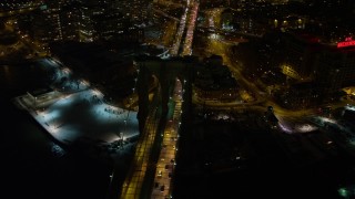 AX67_0078 - 4.8K aerial stock footage view of flying by Brooklyn Bridge at night, New York