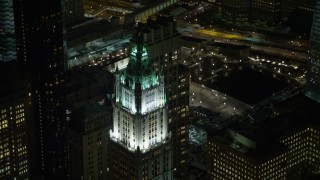 AX67_0089 - 4.8K aerial stock footage view of flying by top of Woolworth Building at night, Lower Manhattan, New York