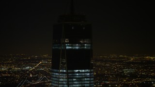 AX67_0091 - 4.8K aerial stock footage view of orbiting top of One World Trade Center at night, Lower Manhattan, New York