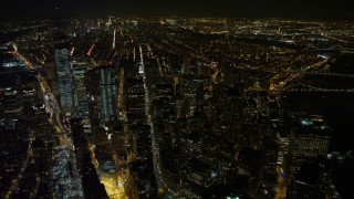 AX67_0095 - Aerial stock footage of 4.8K aerial video view of the south end of Lower Manhattan at night, New York