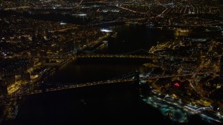 AX67_0096 - 4.8K aerial stock footage view of approaching Brooklyn Bridge, Manhattan Bridge at night, New York