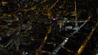 AX67_0101 - 4.8K aerial stock footage view of flying by skyscrapers in Brooklyn at night, New York