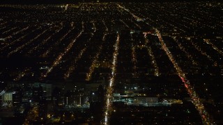 AX67_0104 - Aerial stock footage of 4.8K aerial video view of flying over apartment buildings and reveal hospital in Brooklyn at night, New York